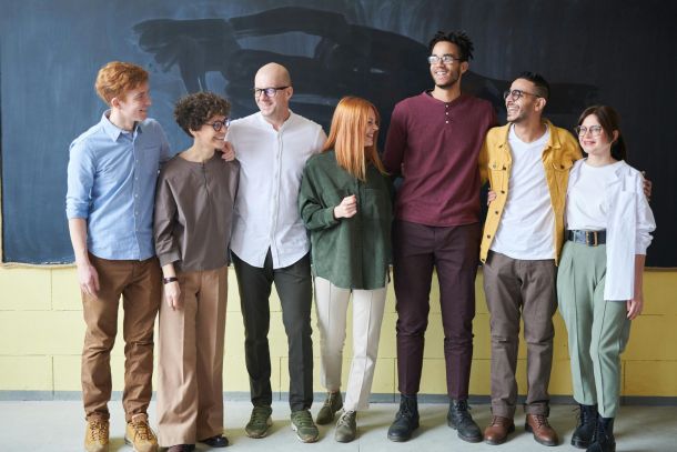 Group of work people lined up with chalkboard behind